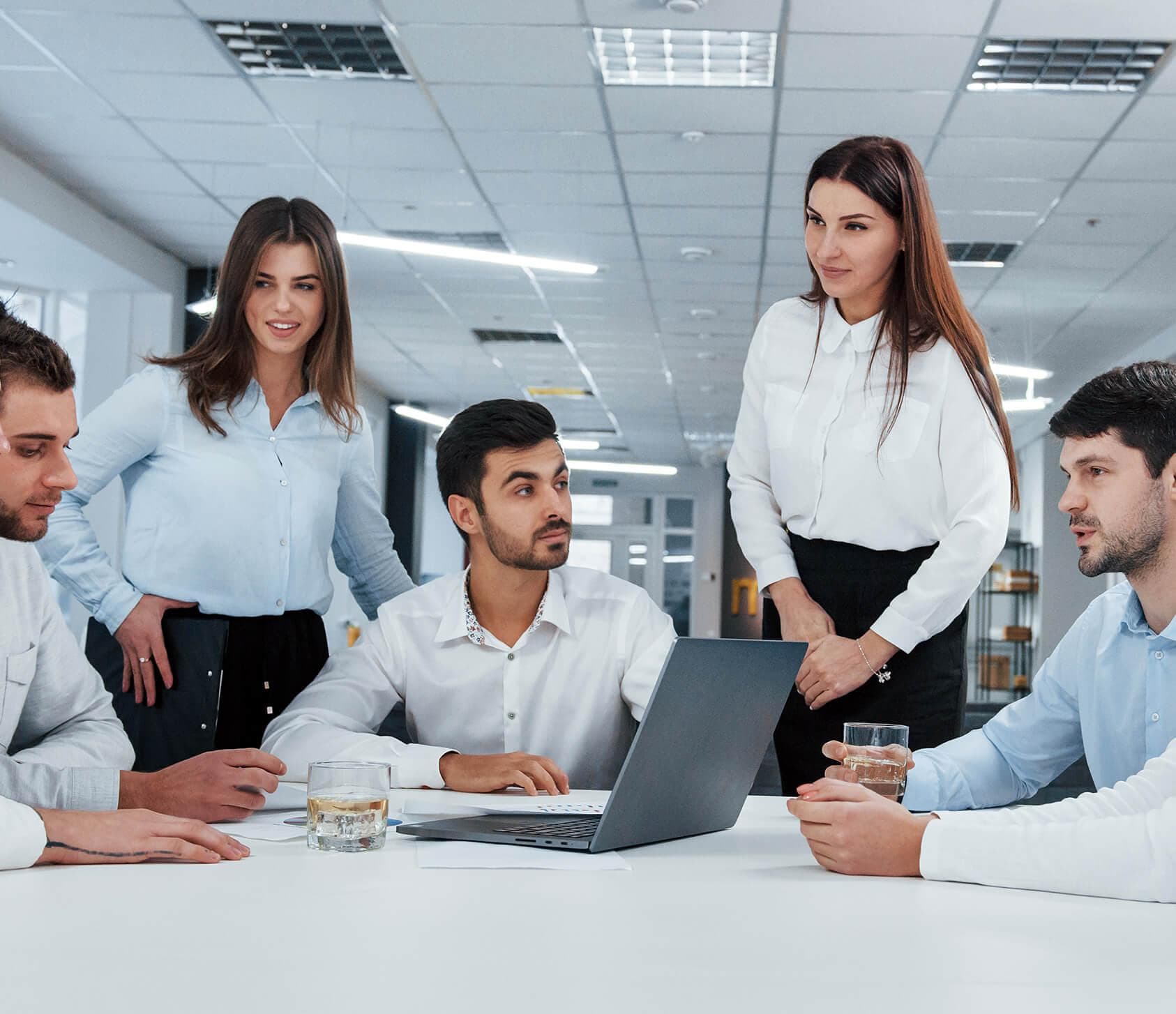 An American Incentive Advisors advisor reviewing a client's records at a conference table.